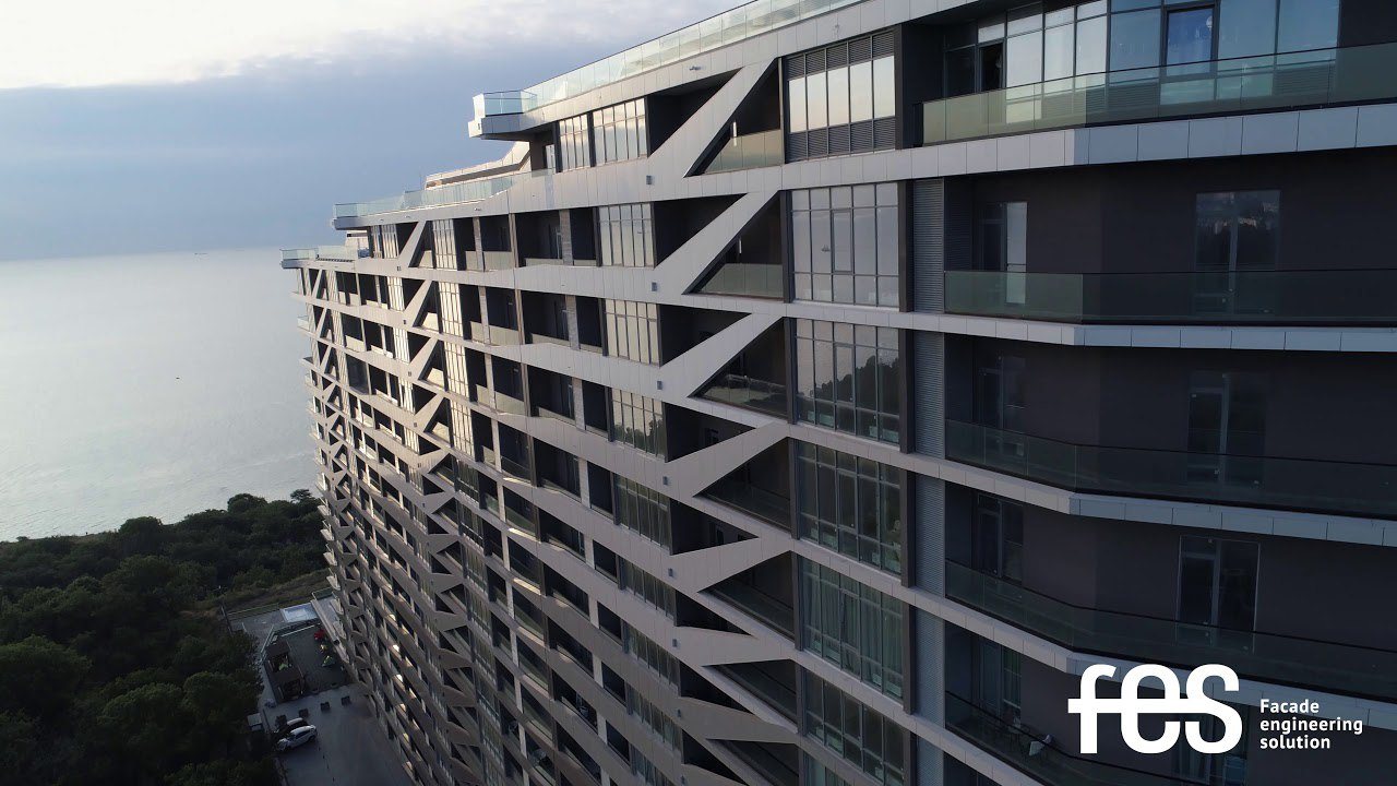 The GreenWood façade from the sea side: diagonal sunshade elements and balcony glazing